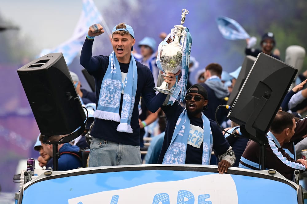 Coventry City goalkeeper (on loan from Brighton and Hove Albion) Carl Rushworth (19) and Coventry City defender (on loan from Brentford) Frank Onyeka (16)  holding the Championship trophy during the Promotion Parade for Coventry City at the Coventry Building Society Arena, Coventry, UK on 4 May 2026.